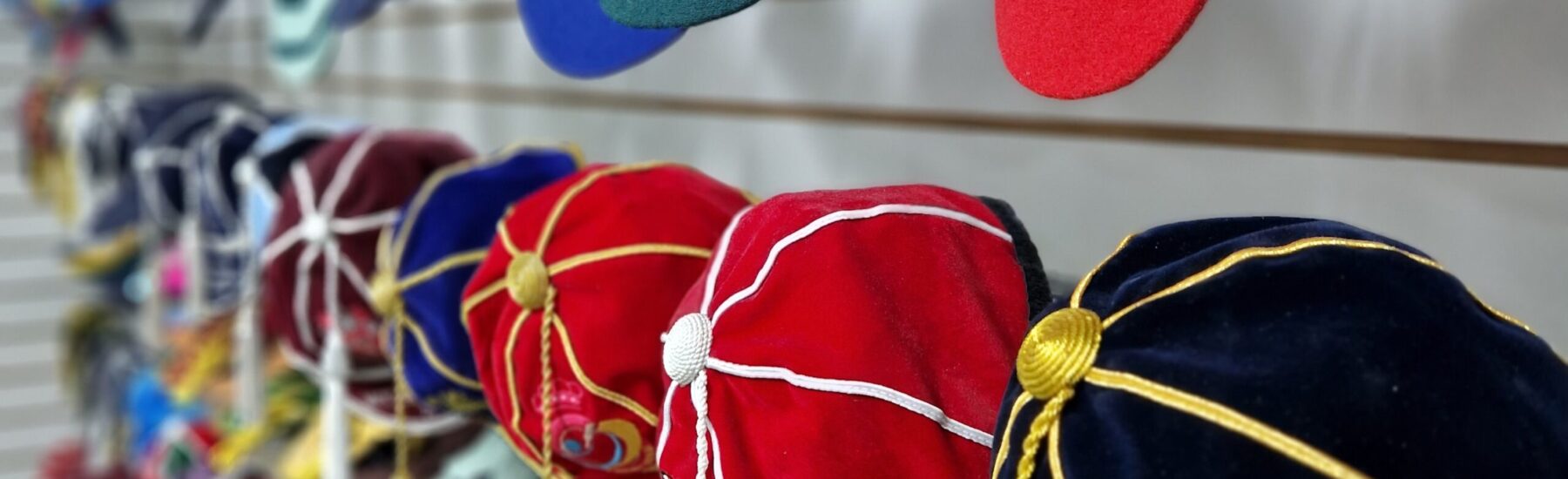 3 rows of honour caps that are hung on a wall for display at Gentlemen and Players shop in High Wycombe