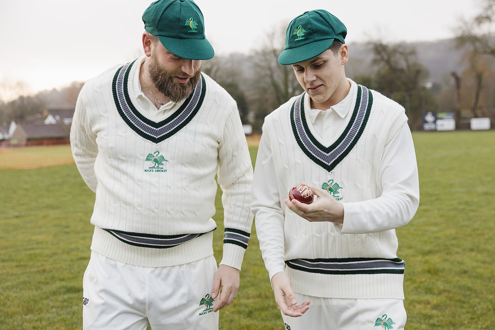 Two cricketers wearing a traditionally knit cricket jumper